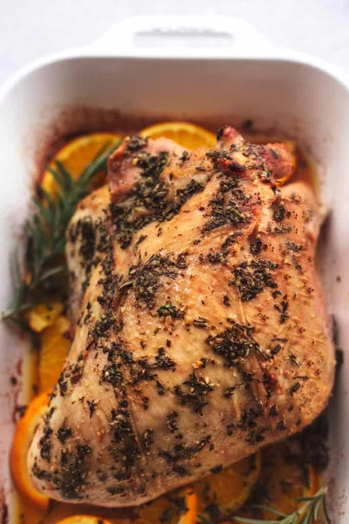 up close baked turkey breast with herbs and orange slices