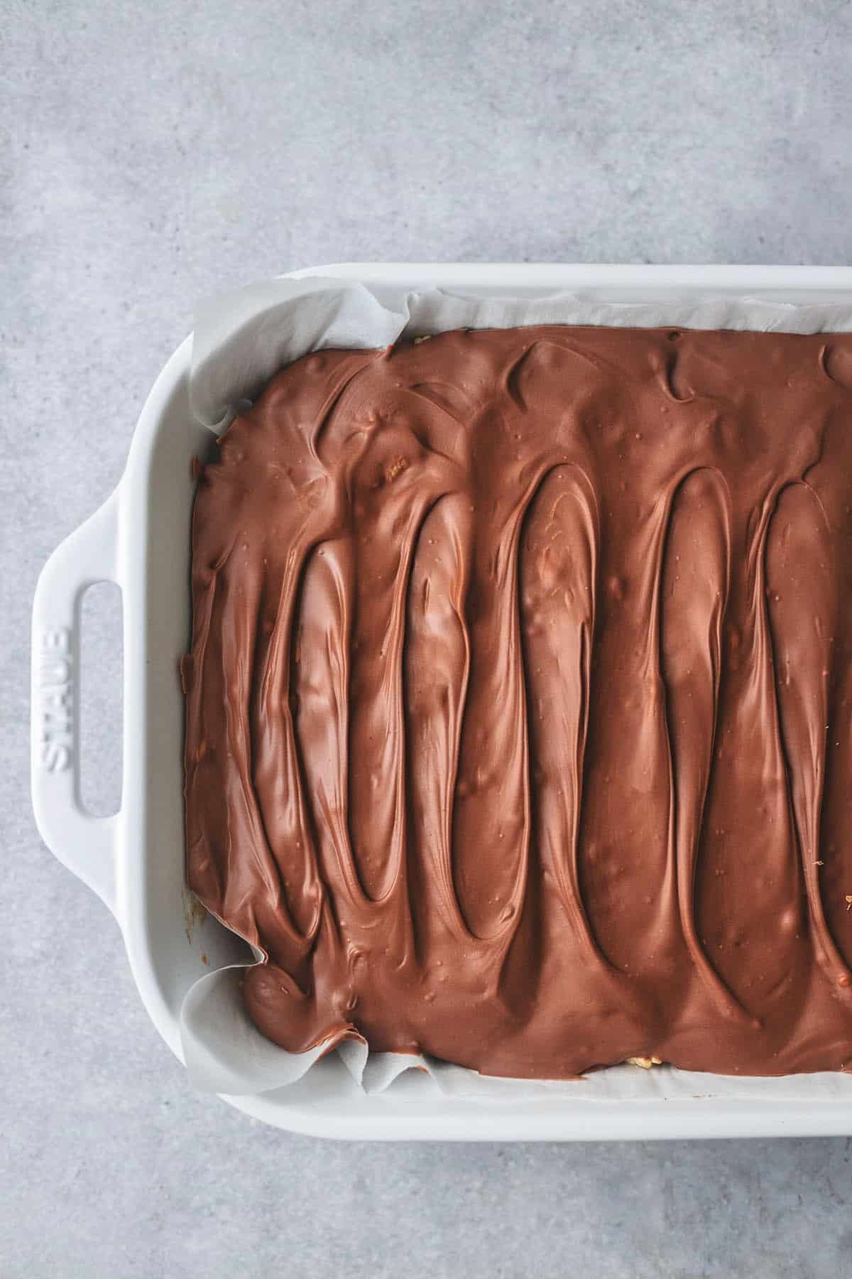 un cut dessert bars with chocolate topping in a pan