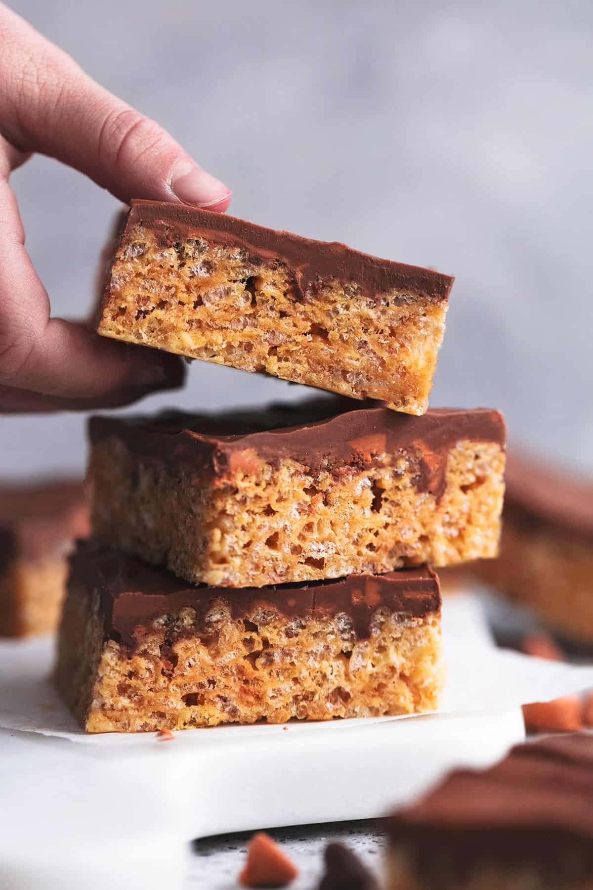 hand lifting single desert bar from a stack