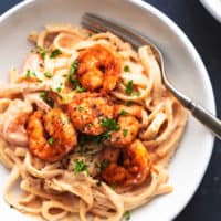 cajun shrimp alfredo pasta in a bowl with a fork