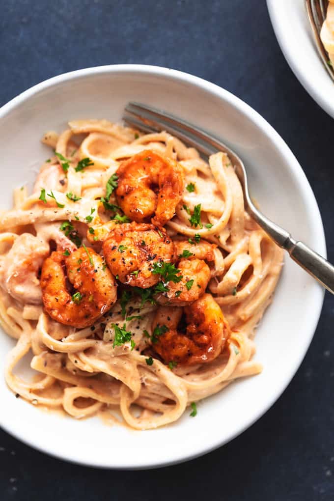 cajun shrimp alfredo pasta in a bowl with a fork