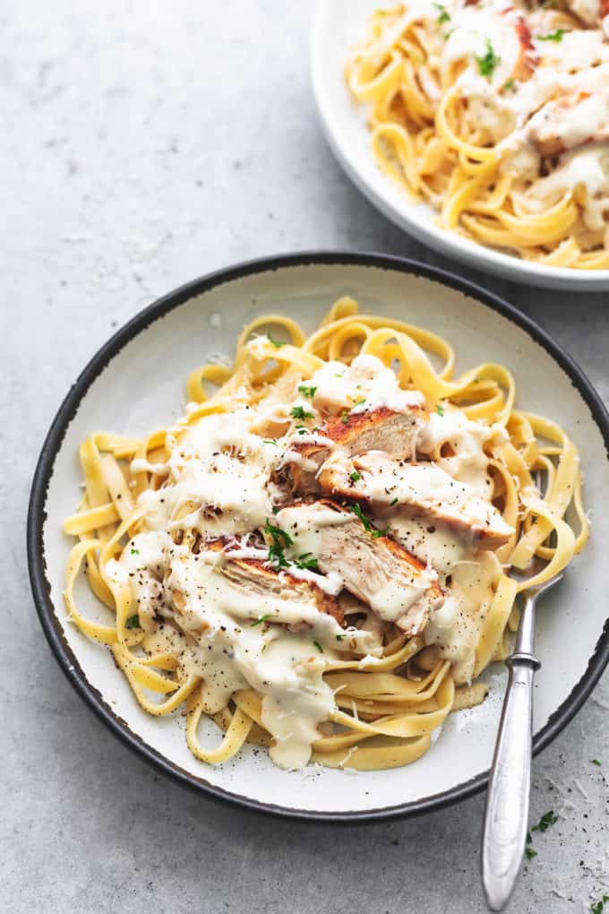 plate of fettuccine noodles with white sauce and chicken