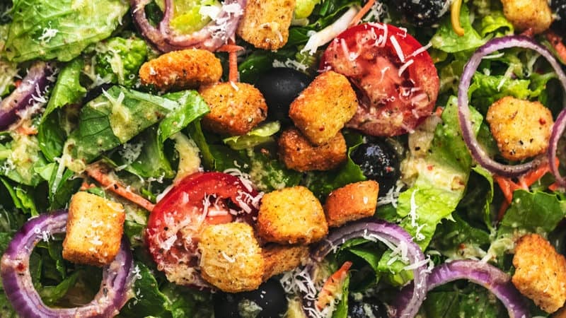 bowl of salad with serving spoons