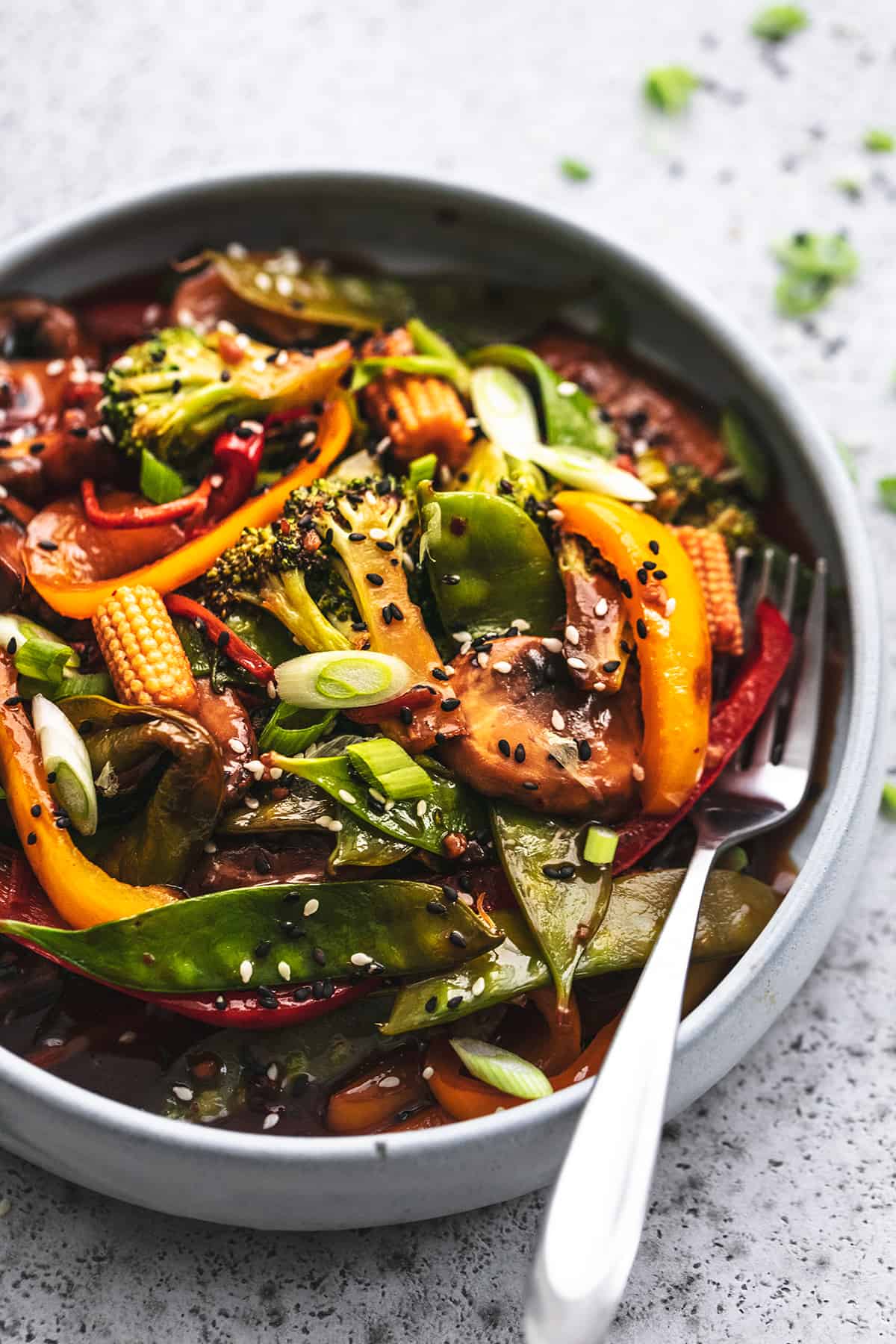 vegetable stir fry in bowl with fork