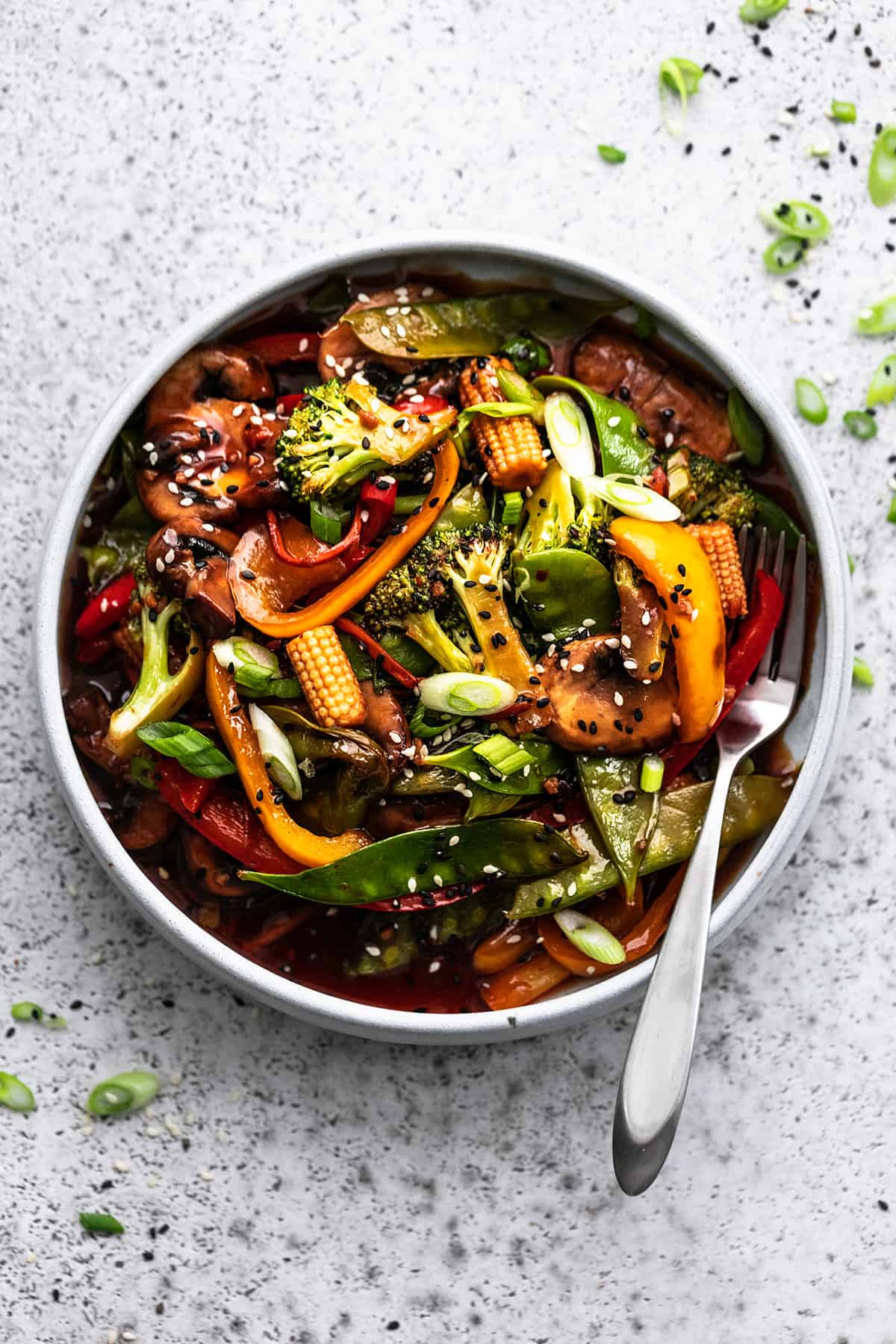 overhead view of plate of cooked vegetables with fork