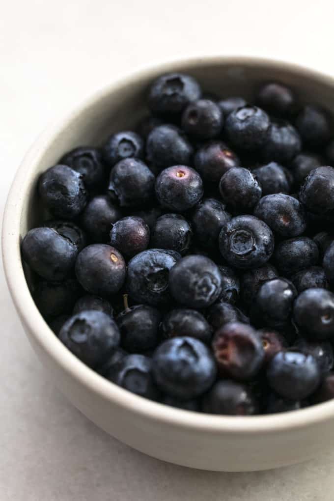 up close view of blueberries in stone bowl