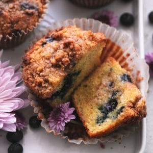 blueberry muffin cut in half with butter spread on