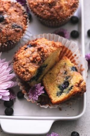 blueberry muffin cut in half with butter spread on