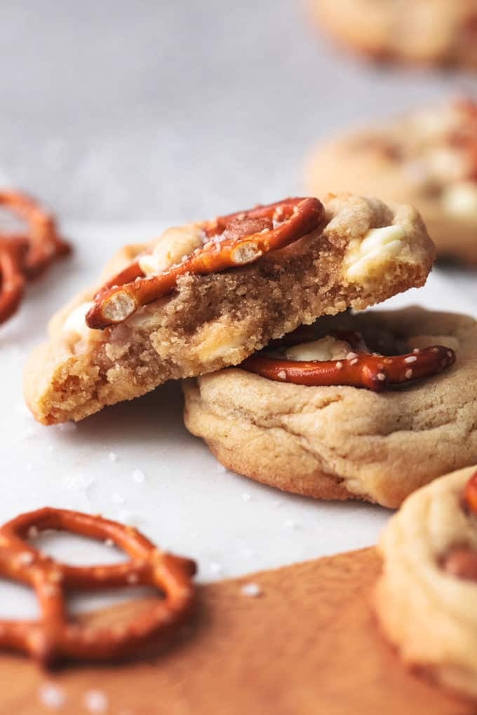 cross section of caramel white chocolate chip cookies on marble cutting board