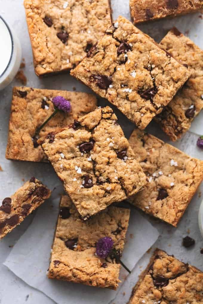 oatmeal cookie bars layered on a table with glass of milk