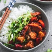 chinese chicken with veggies and rice in a bowl