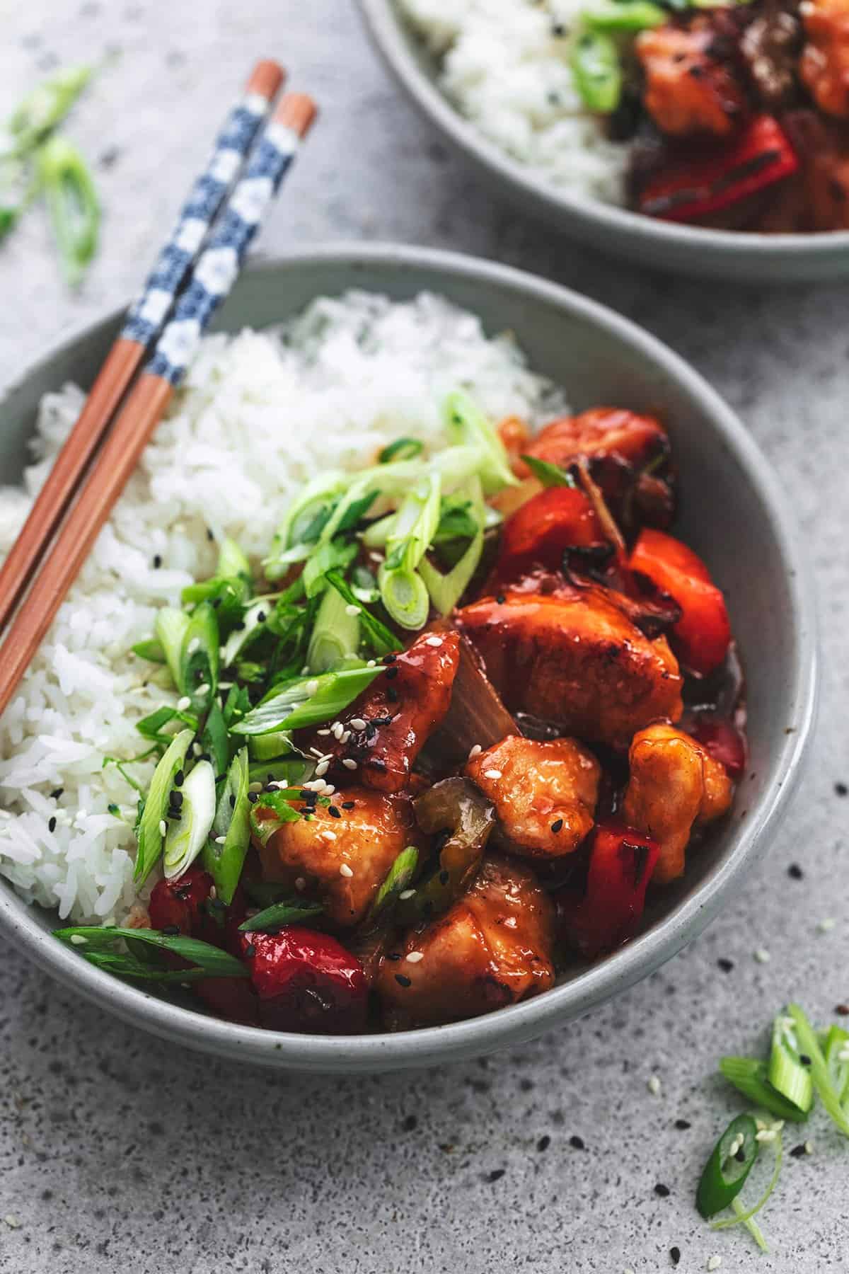 chinese chicken with veggies and rice in a bowl