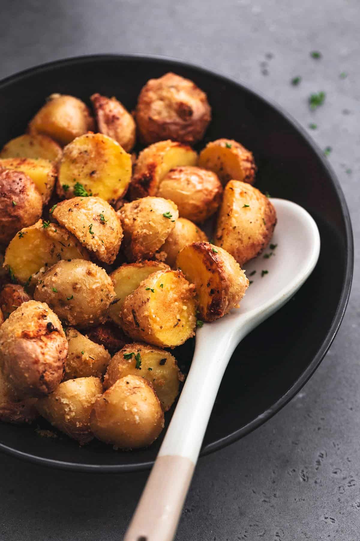 air fryer potatoes in a bowl with serving spoon