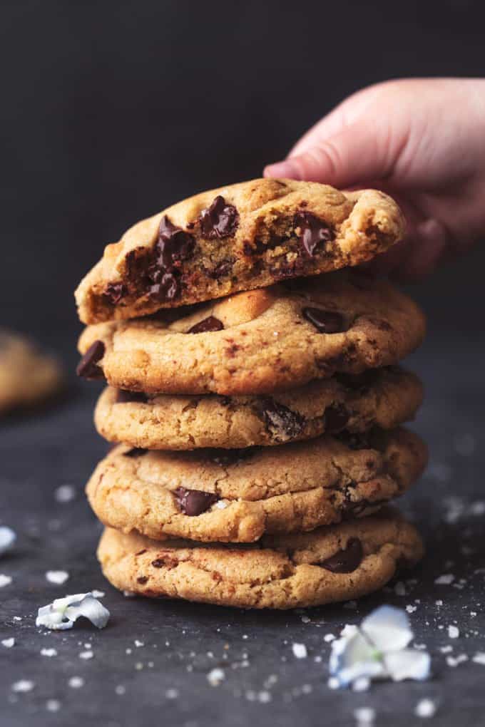 small hand lifting the top cookie from a stack of more cookies