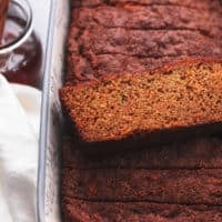 single slice of carrot cake bread on top of more slices in a loaf pan