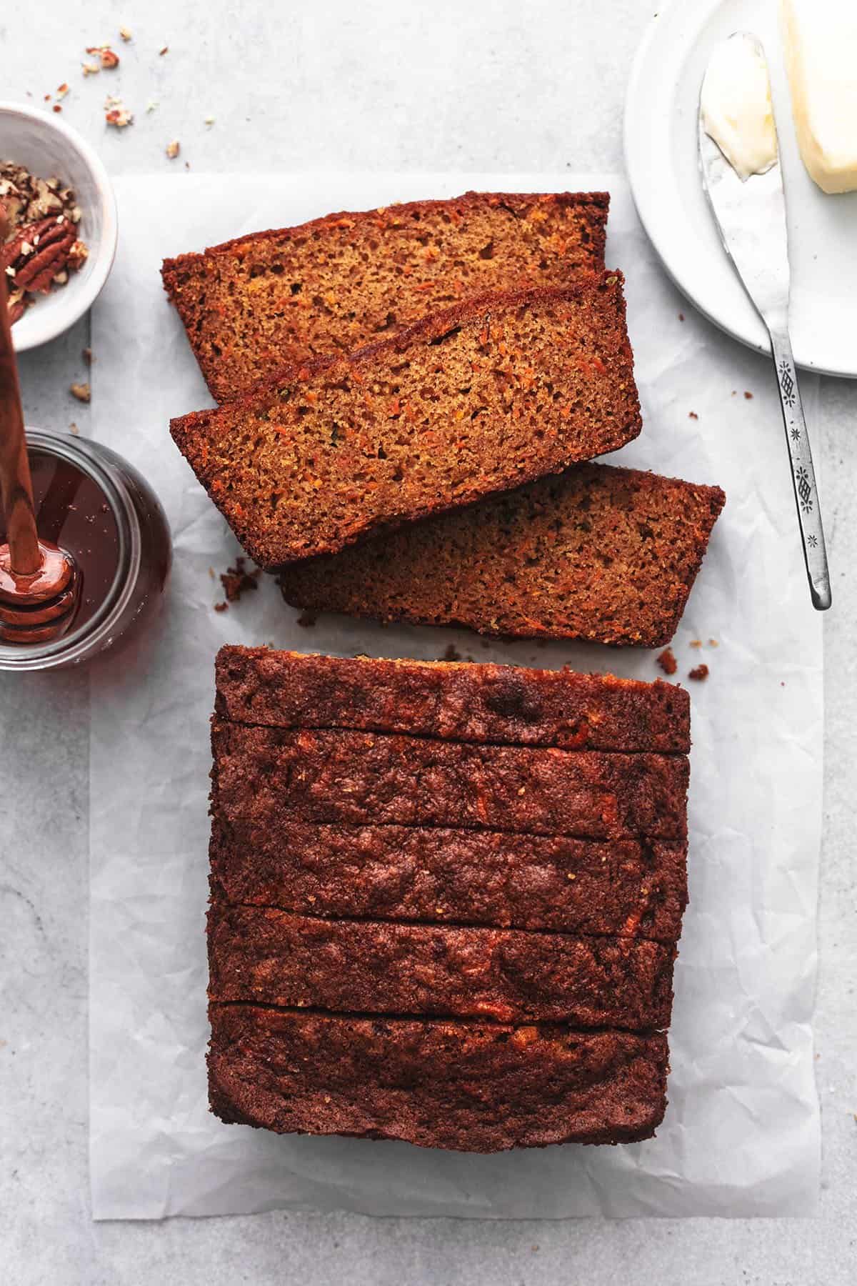 sliced carrot cake bread with butter and honey
