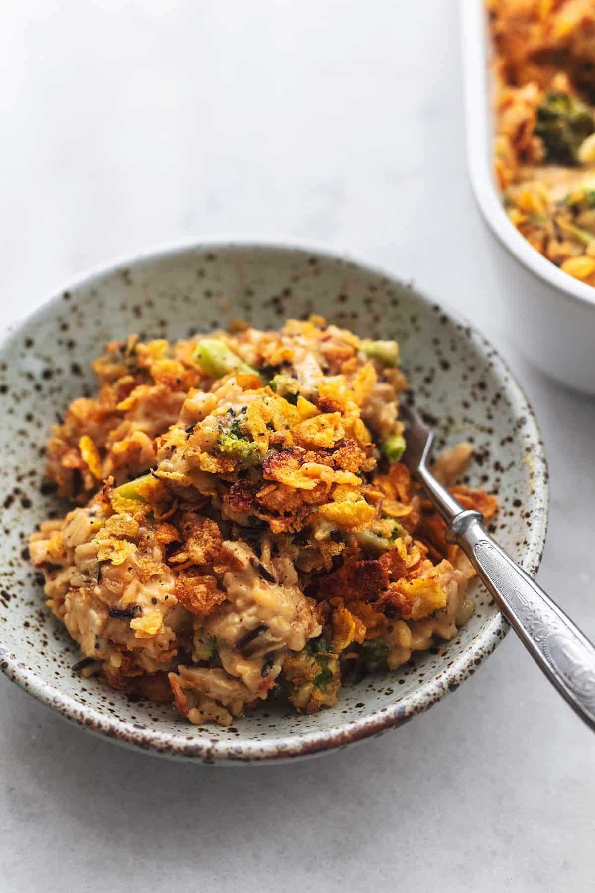 fork in bowl of broccoli, rice, chicken casserole