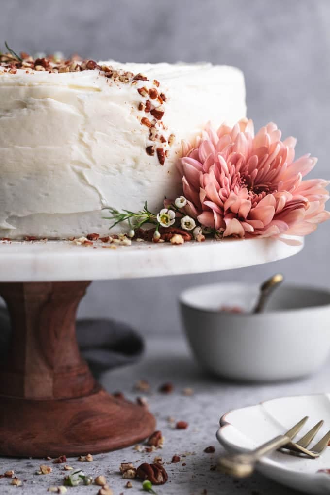 carrot cake with large flower and plate with fork