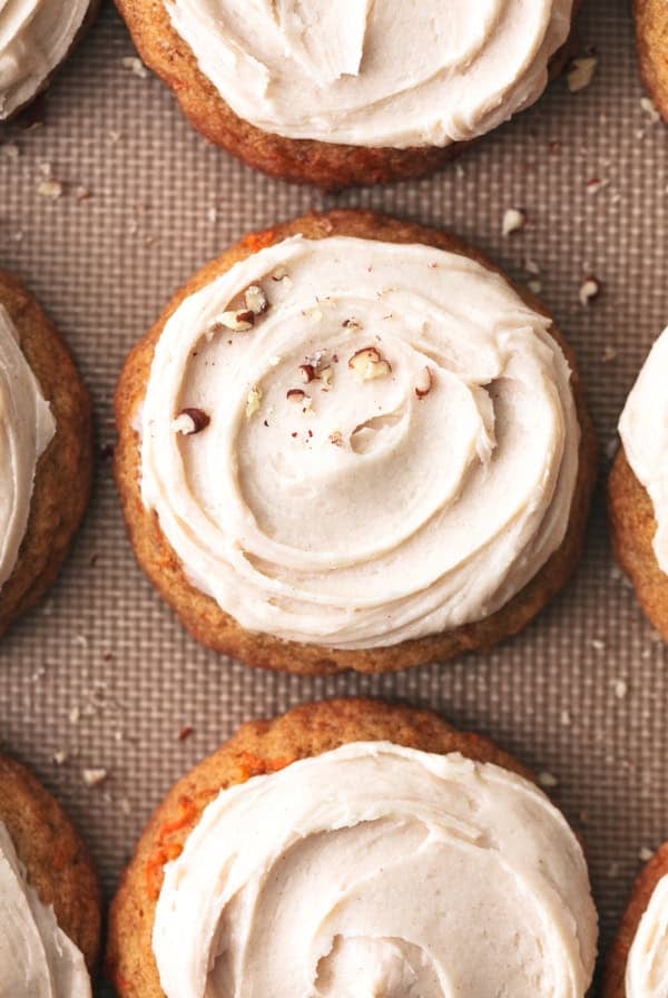 frosted cookies on a baking sheet