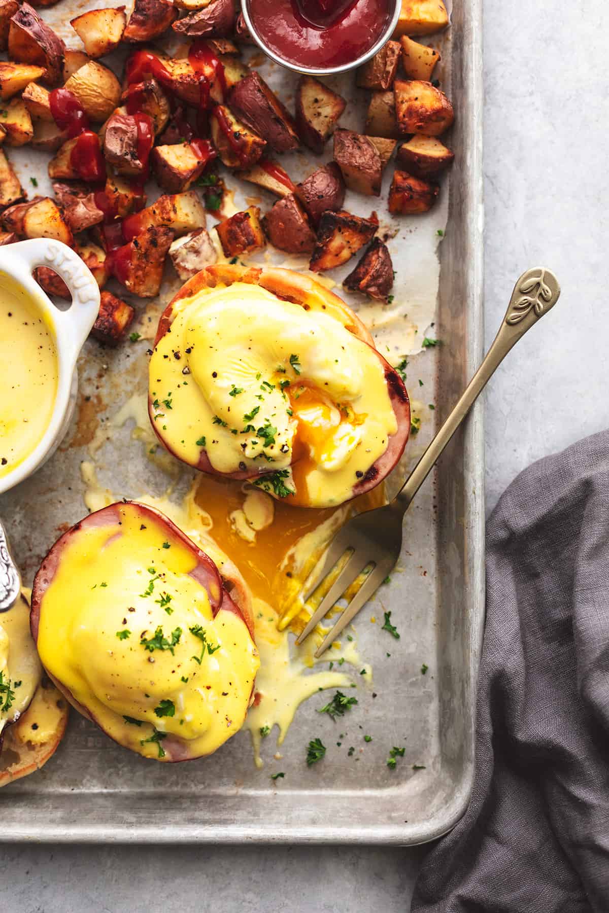 fork digging into eggs benedict