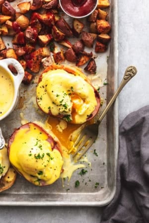 fork digging into eggs benedict