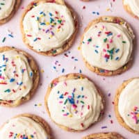 overhead view of many frosted cookies with sprinkles