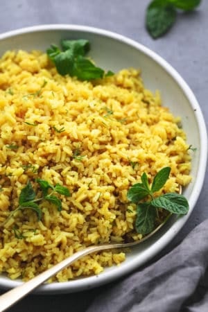 up close view of rice with fresh mint leaves in a bowl