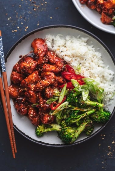 plate of korean fried chicken with broccoli and rice
