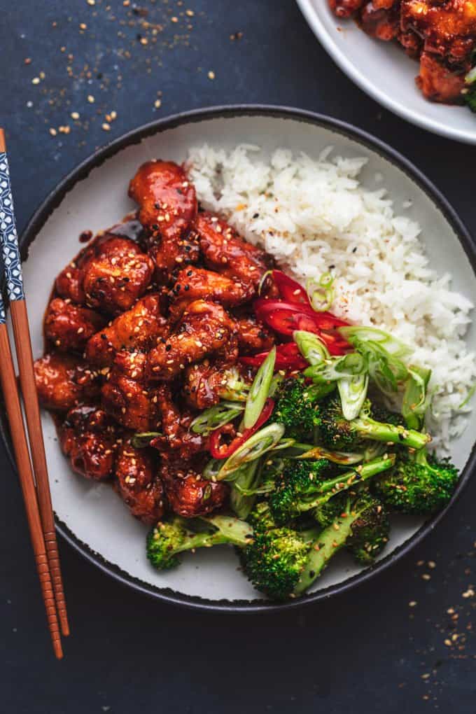 plate of korean fried chicken with broccoli and rice