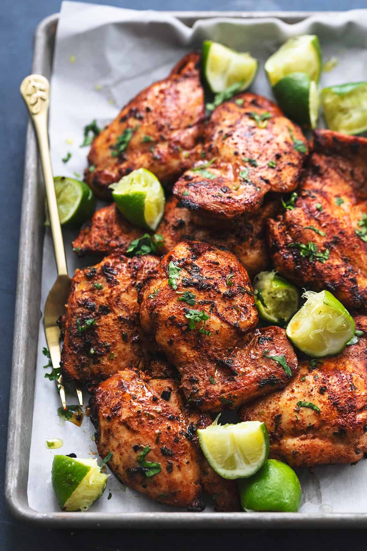 cilantro lime chicken on platter with fork and limes