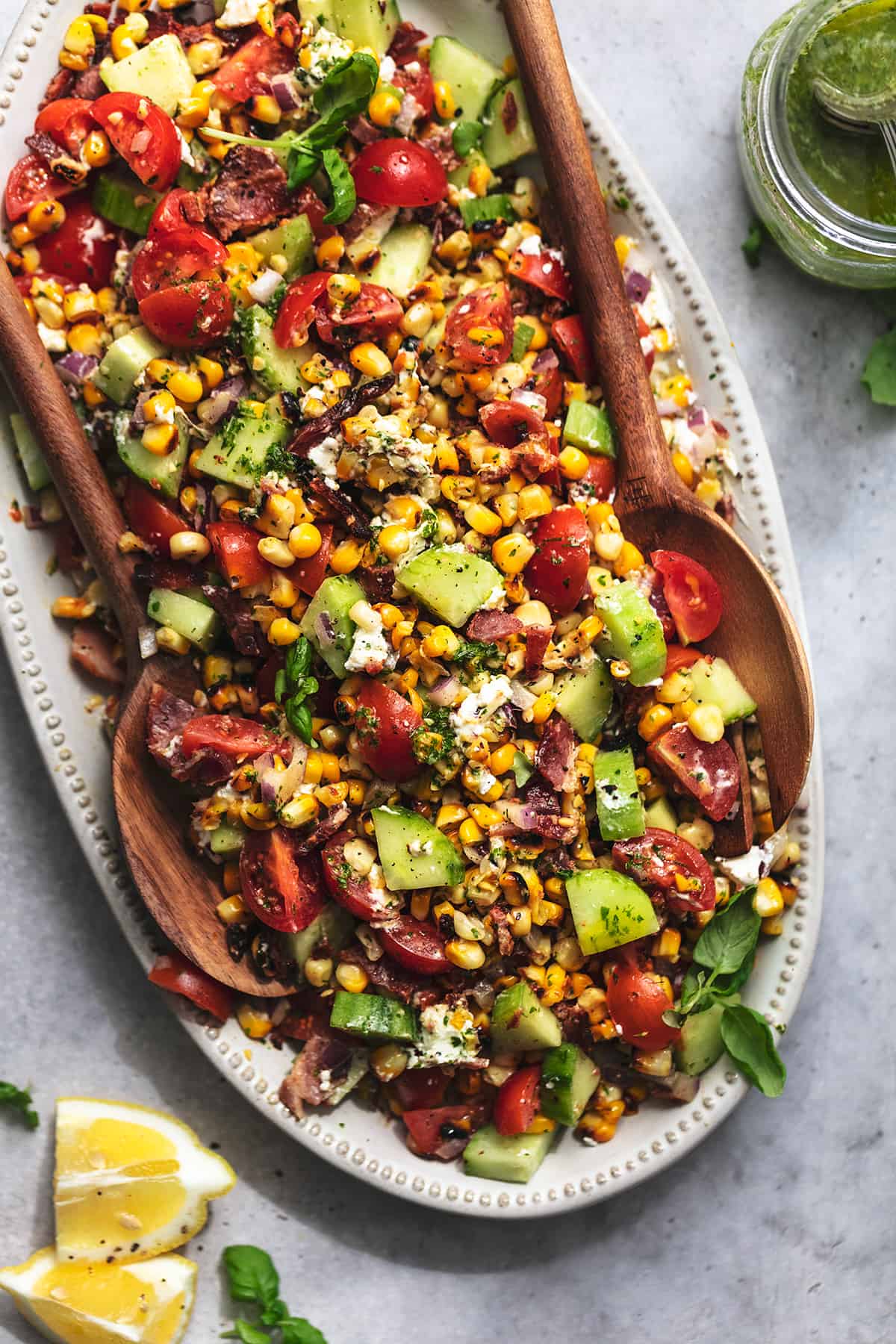 platter of corn salad with serving spoons