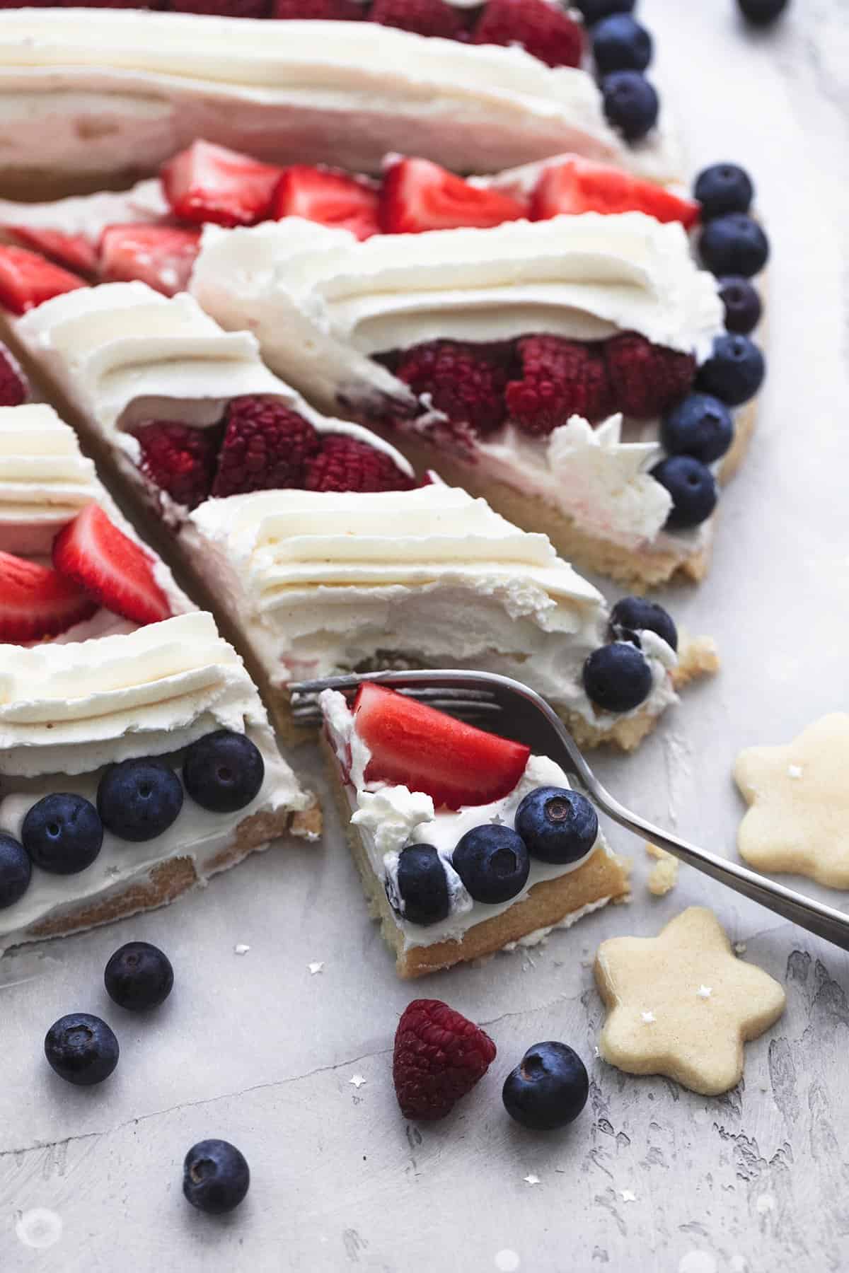 fork cutting into fruit pizza slice