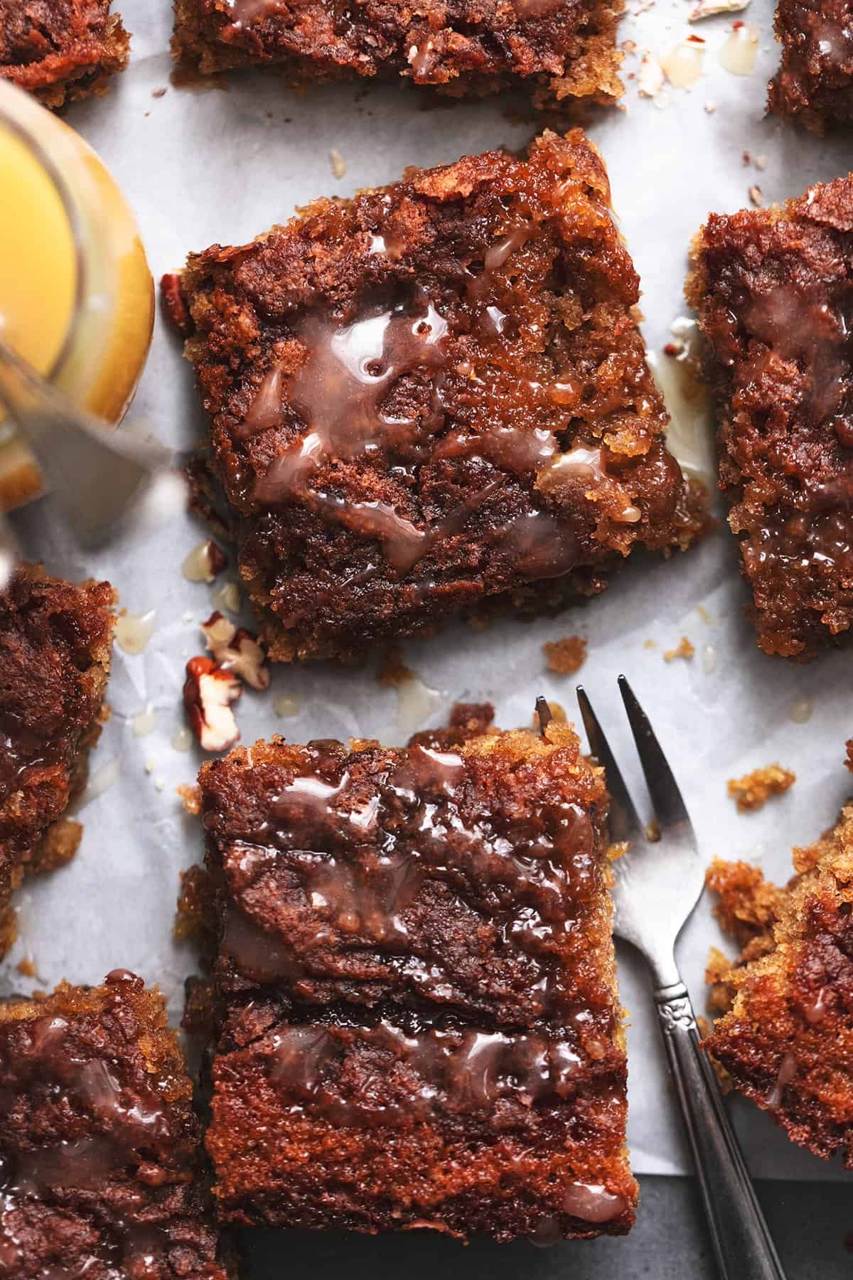 pieces of oatmeal cake on table with fork and jar of sauce