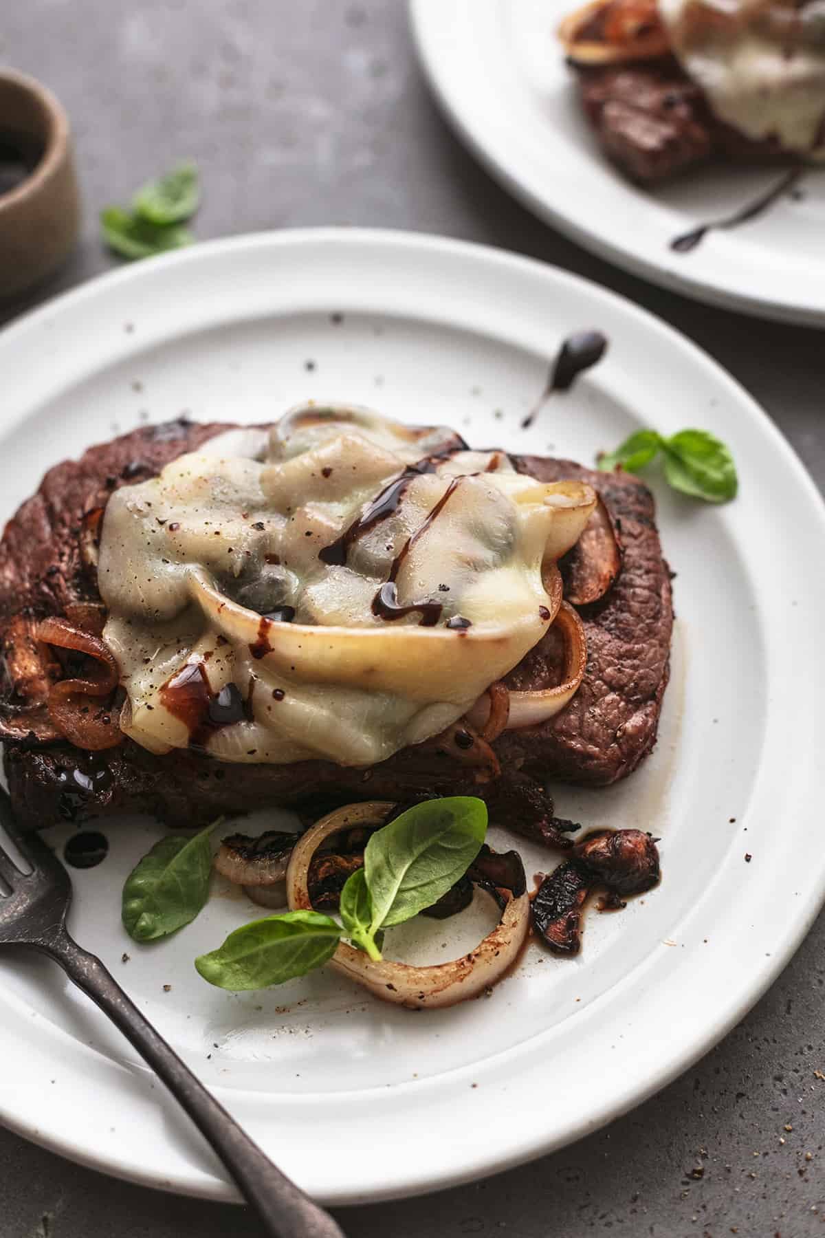 steak with cheese and onions and mushrooms