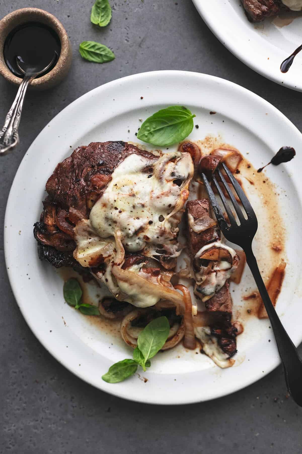 partially eaten steak on plate with fork