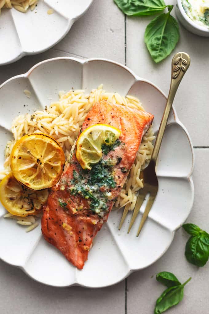 grilled salmon with lemon butter sauce and orzo on plate with fork