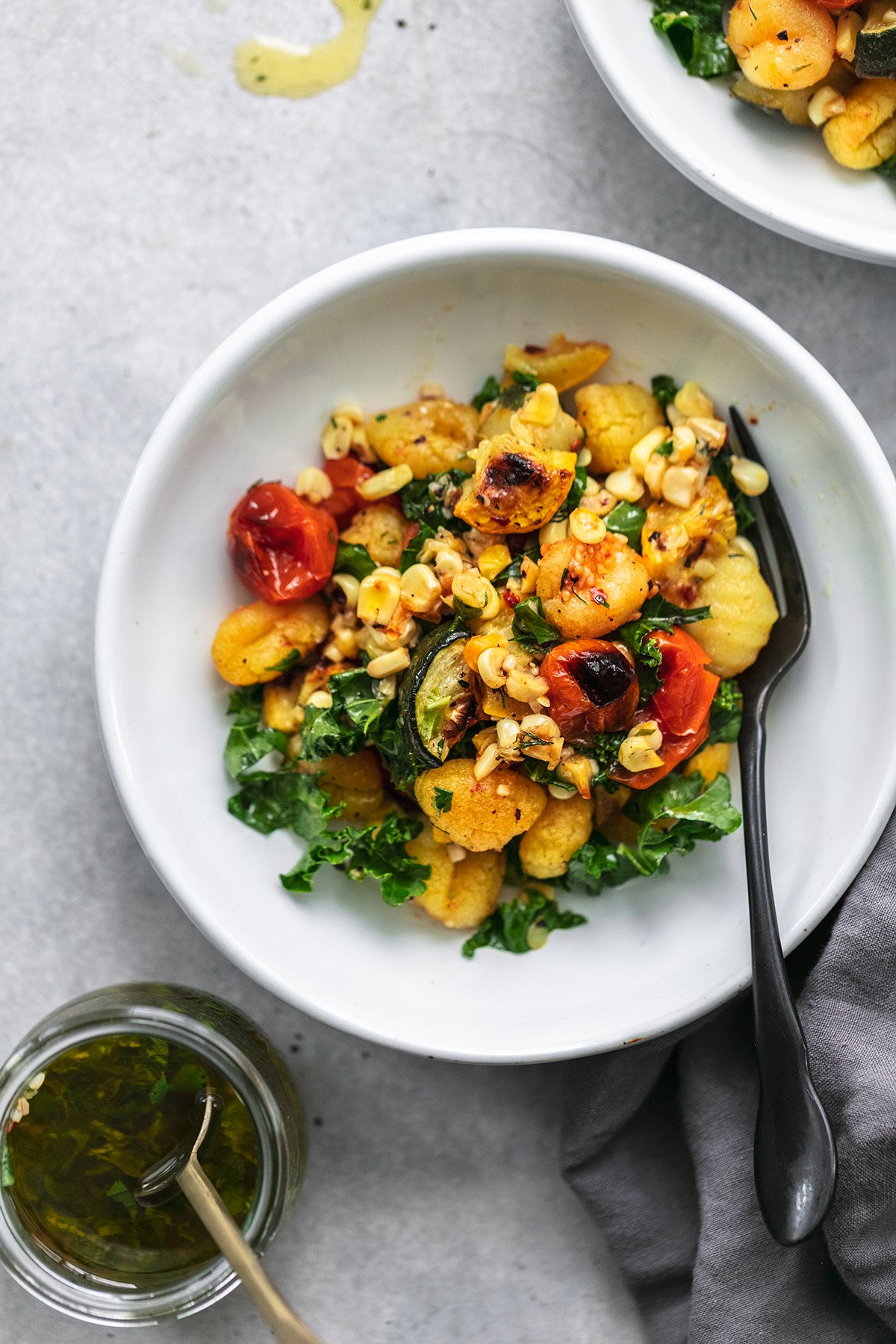 gnocchi with vegetables and dressing in jar