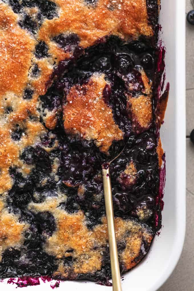 pan of blueberry cobbler with serving spoon