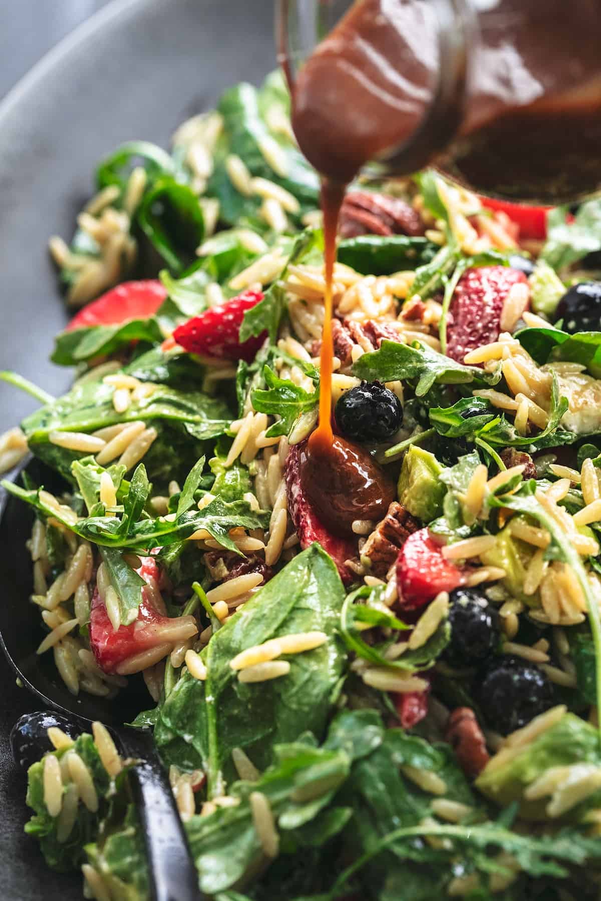 balsamic dressing pouring onto salad