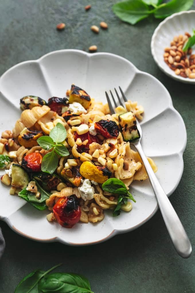 pasta on a plate with vegetables and fork