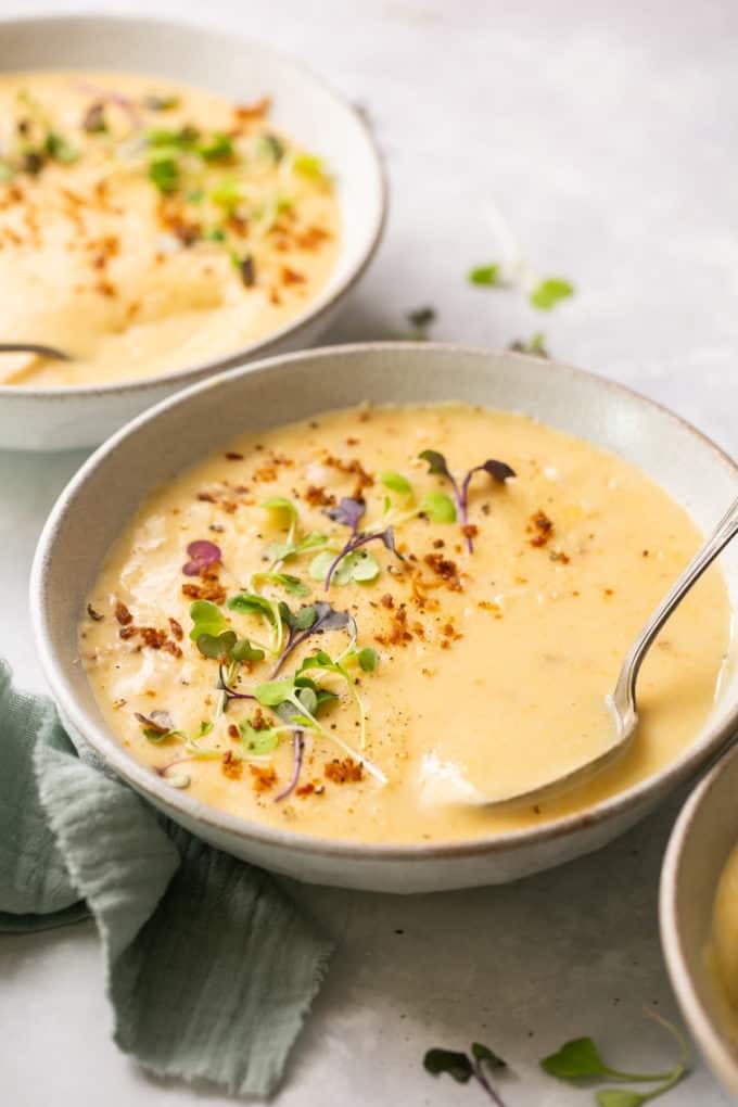 cheddar potato soup in bowl with spoon
