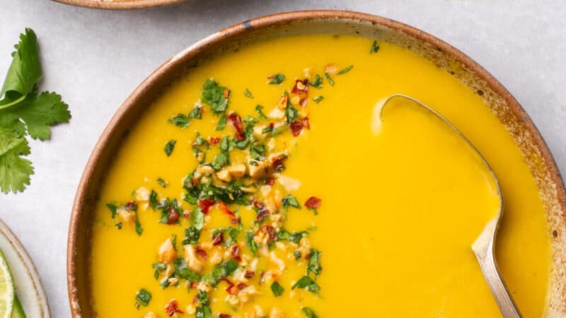 overhead view of two bowls of curried butternut squash soup