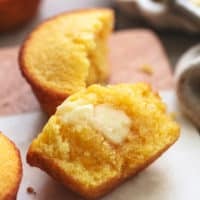 half of a cornbread muffin with butter
