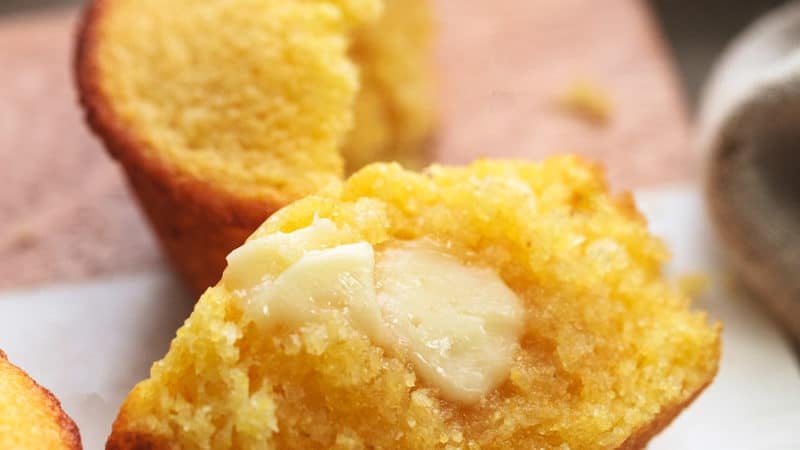 half of a cornbread muffin with butter