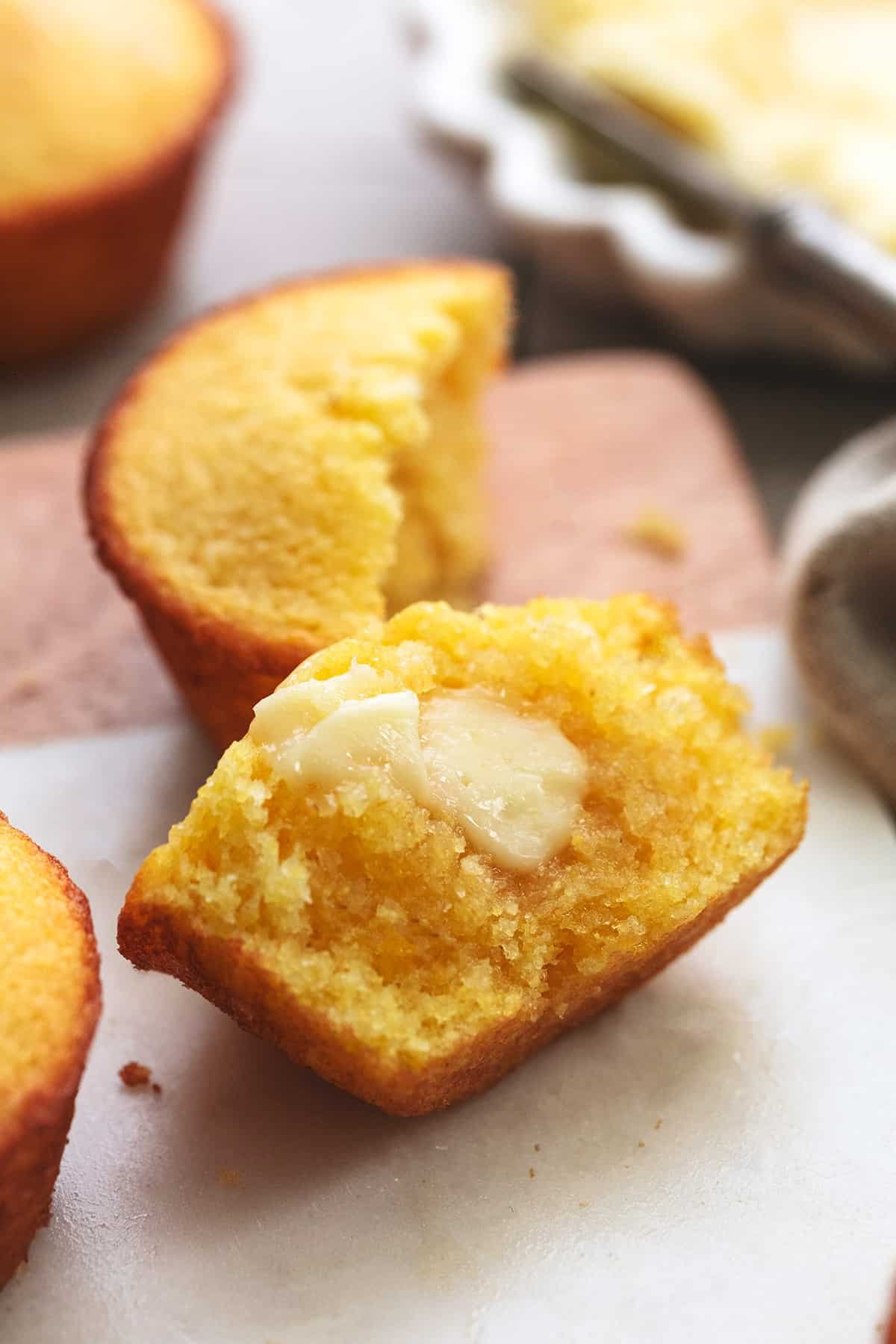 half of a cornbread muffin with butter