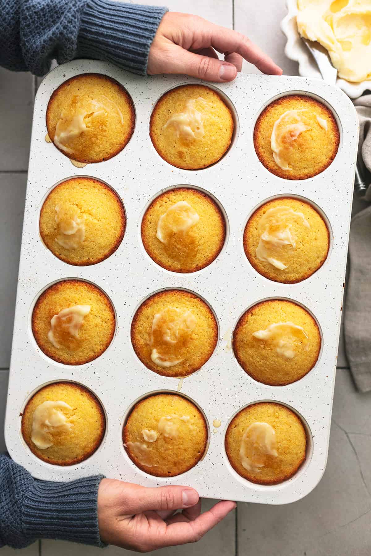 hands holding muffin tin