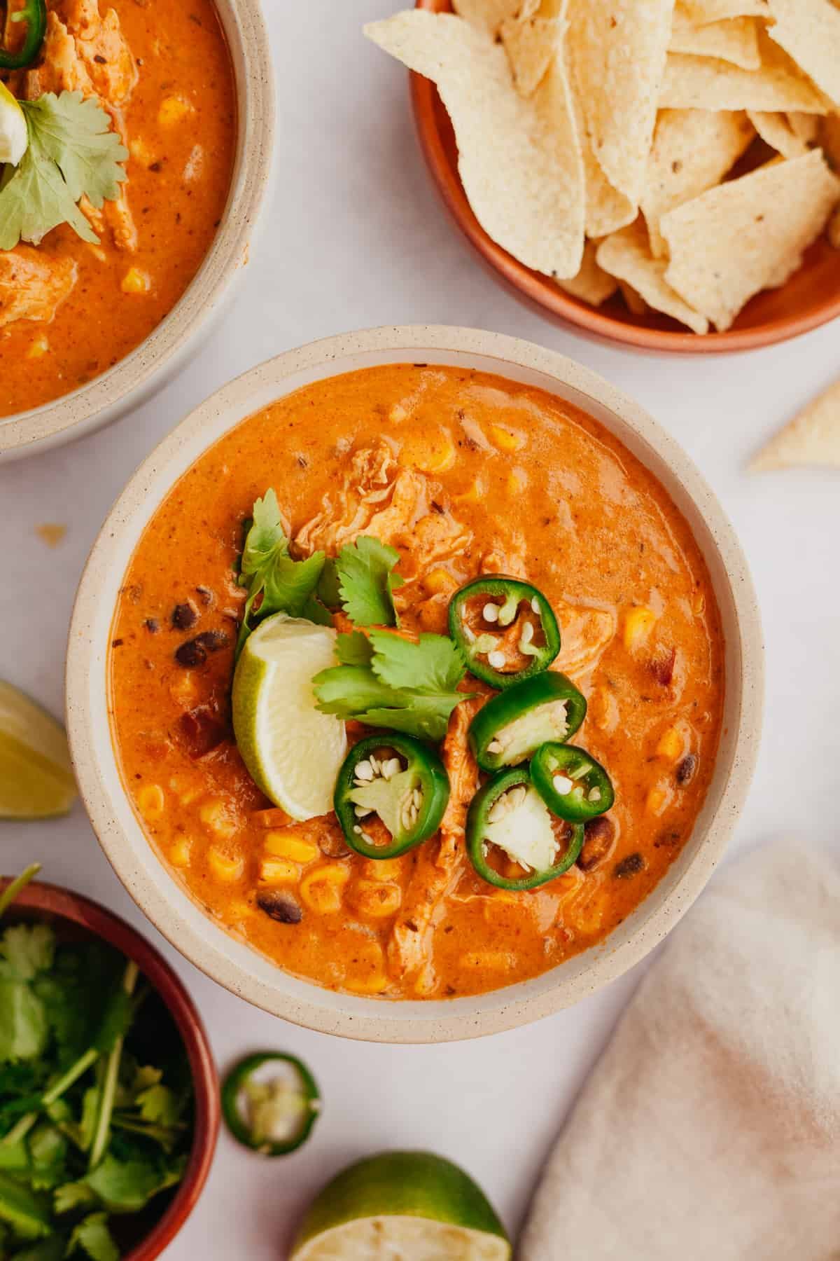 bowls of enchilada soup and bowls of toppings