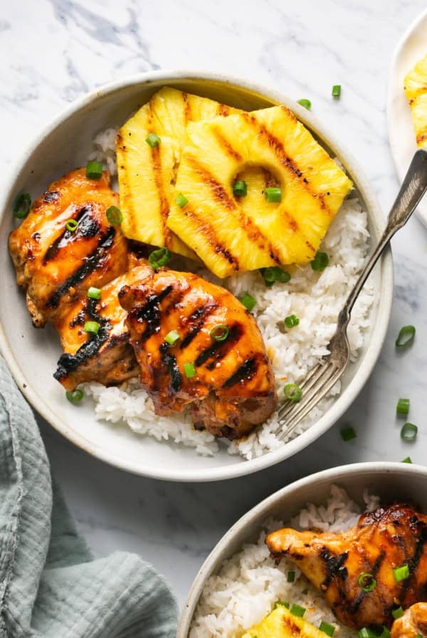 hawaiian huli huli chicken with rice and pineapple on platter