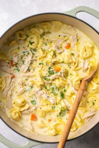 pot of soup with shredded chicken and tortellini noodles