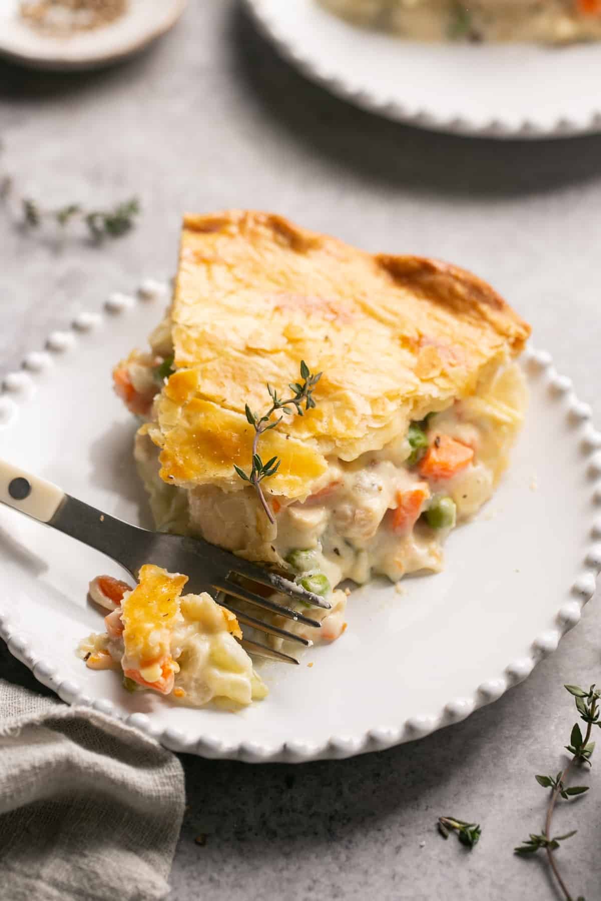 fork digging into chicken pot pie slice